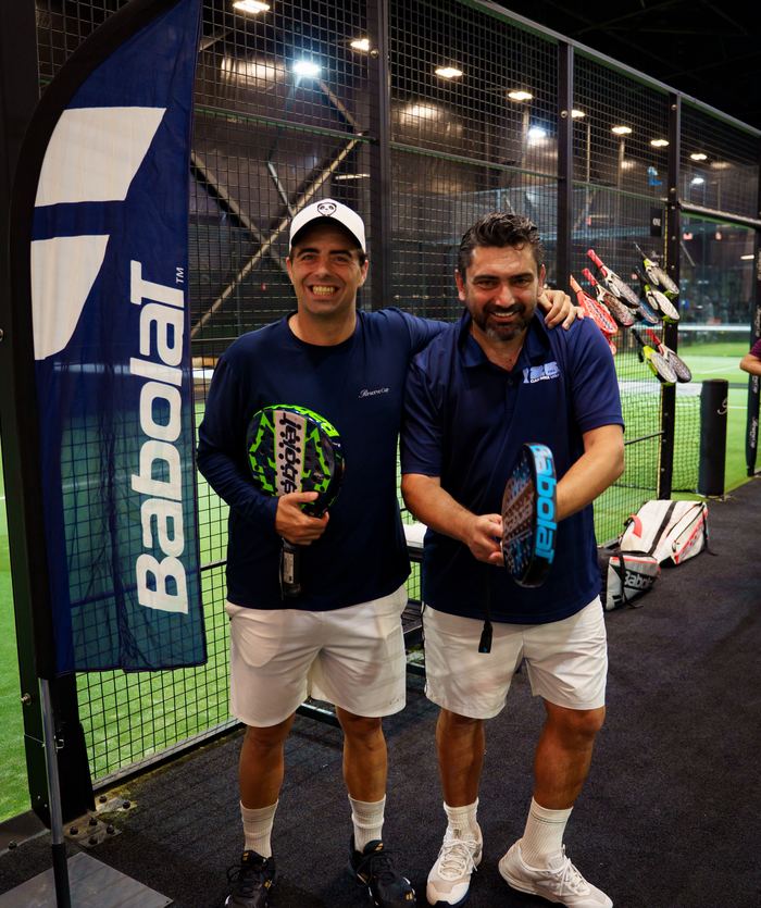 Santi and a friend with new racquets at a brand stand